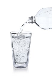 Photo of Pouring soda water from bottle into glass on white background