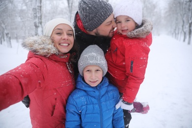 Photo of Happy family taking selfie outdoors on winter day. Christmas vacation