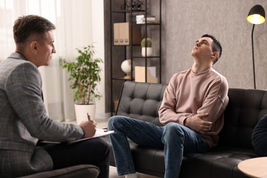 Photo of Professional psychotherapist working with patient in office