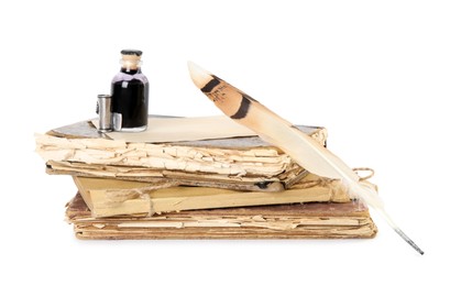 Feather pen, bottle of ink and old books on white background