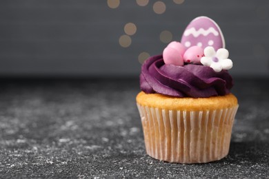 Tasty decorated Easter cupcake on grey table, closeup. Space for text