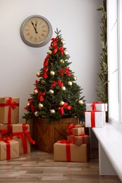 Decorated Christmas tree with gifts. Festive interior