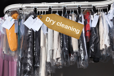 Image of Hangers with clothes on garment conveyor at dry-cleaner's
