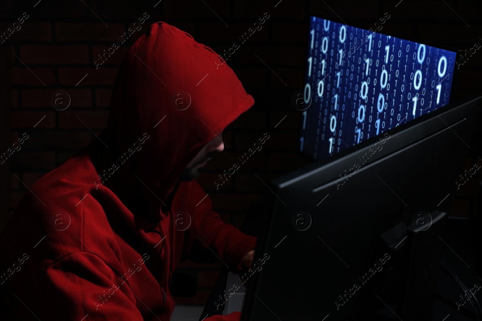 Photo of Hacker working with computers in dark room. Cyber attack