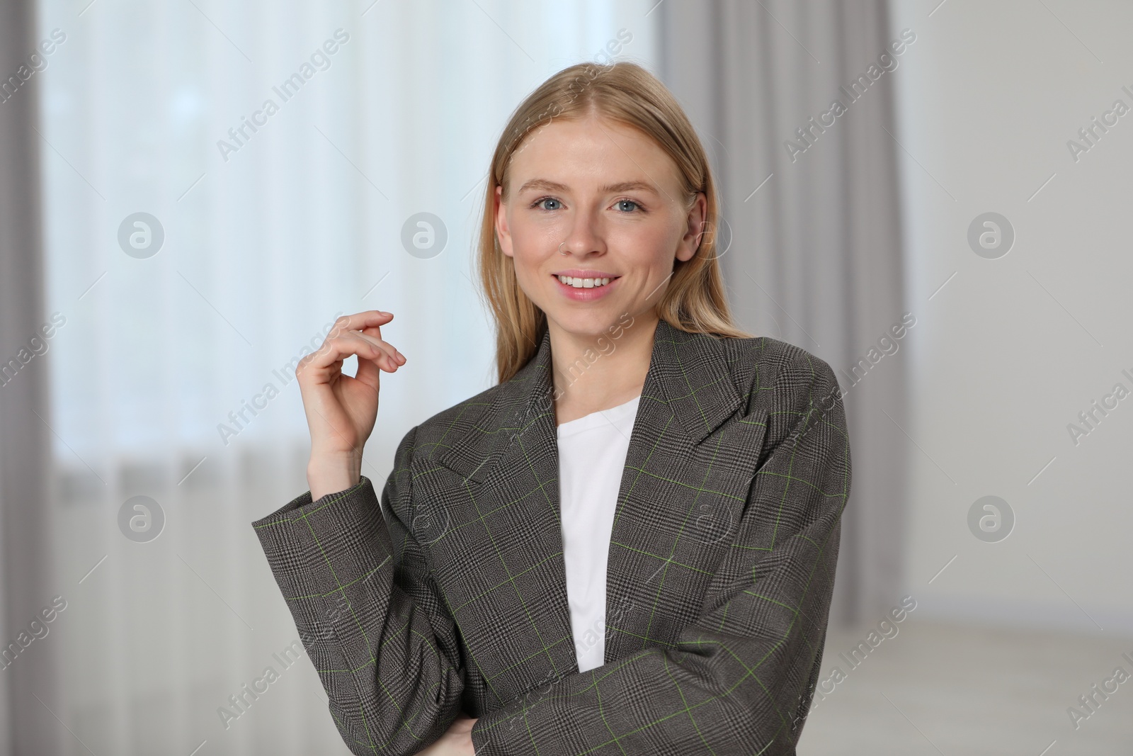 Photo of Portrait of beautiful young woman in stylish jacket indoors