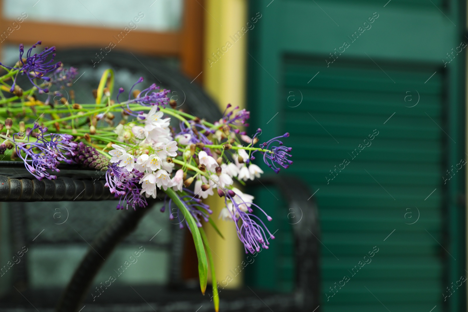 Photo of Beautiful bouquet of wildflowers on table outdoors, closeup. Space for text