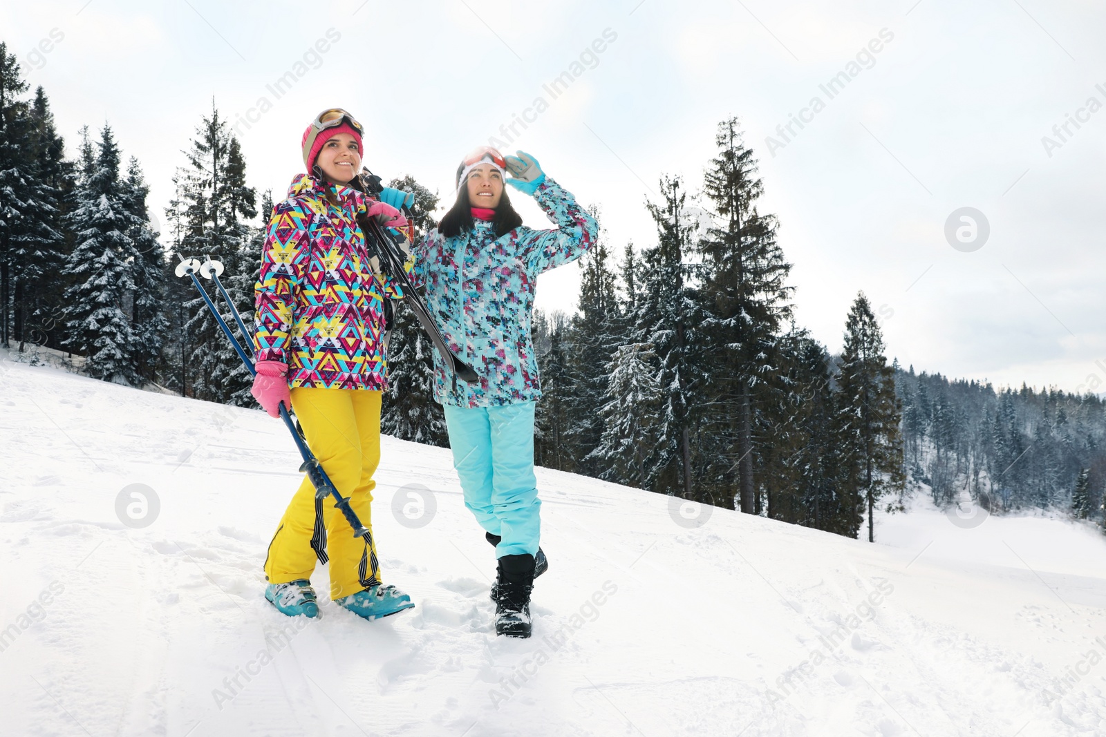 Photo of Young skiers wearing winter sport clothes outdoors