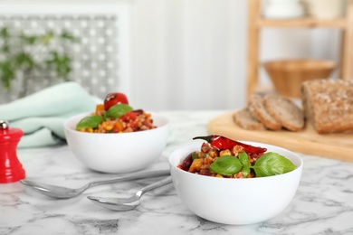 Tasty chili con carne served on marble table. Space for text