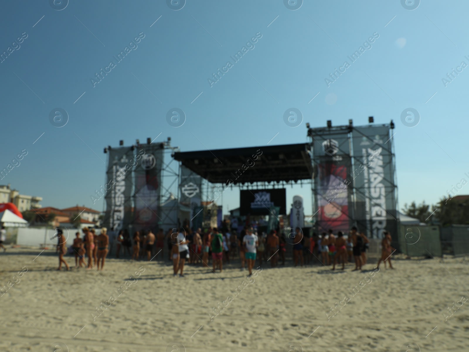 Photo of SENIGALLIA, ITALY - JULY 22, 2022: Blurred view of people enjoying music festival on beach