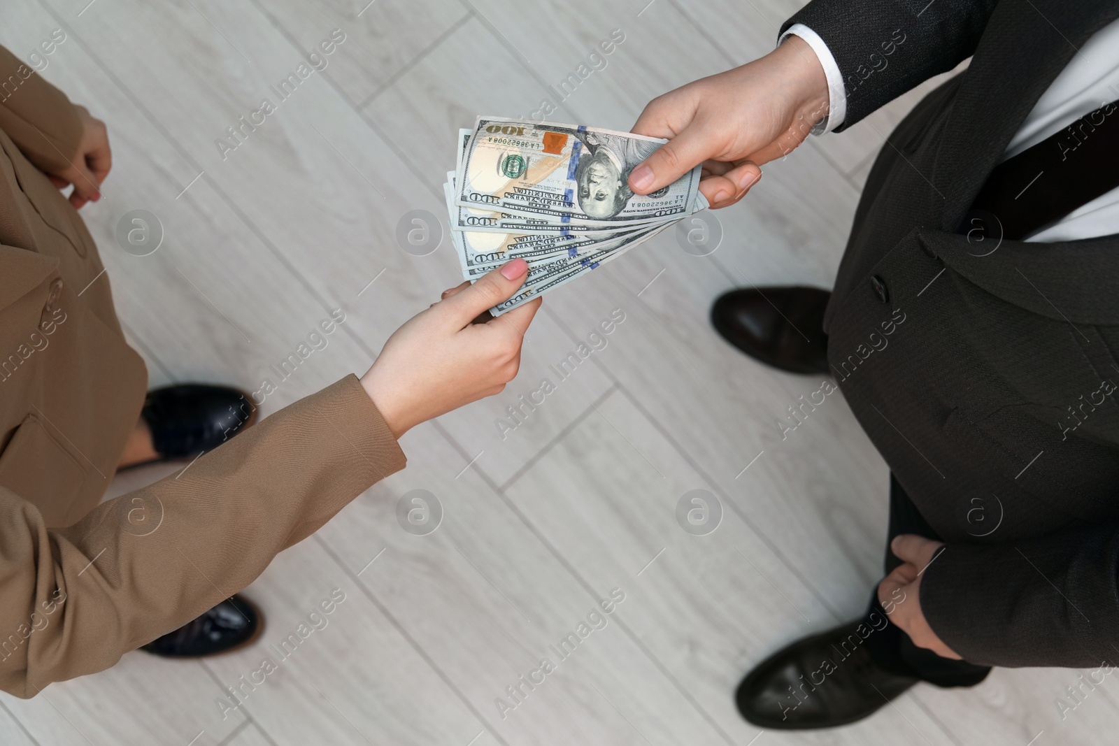 Photo of Man giving money to woman indoors, above view. Currency exchange