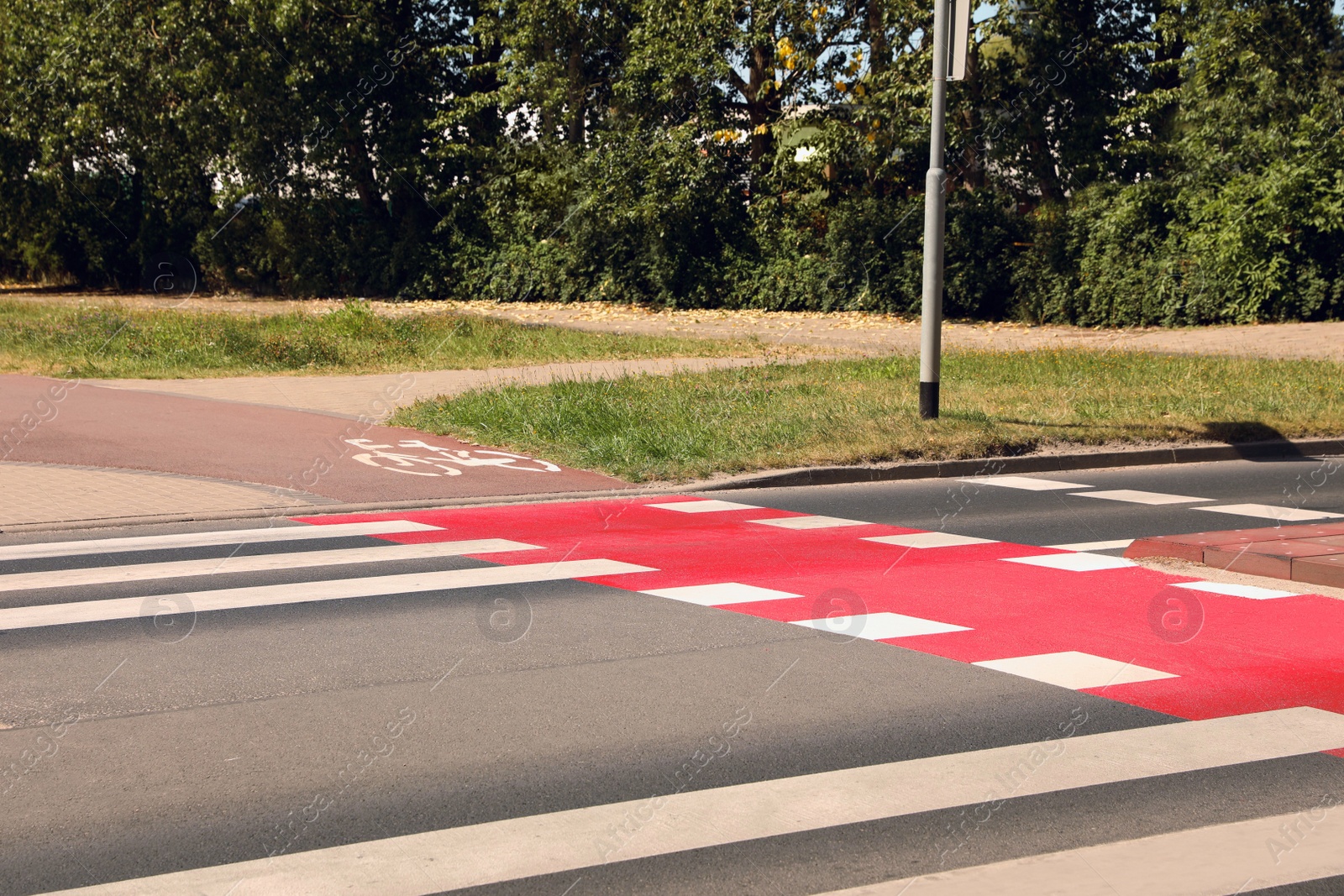 Photo of Bicycle lane with painted white sign and pedestrian crossing outdoors