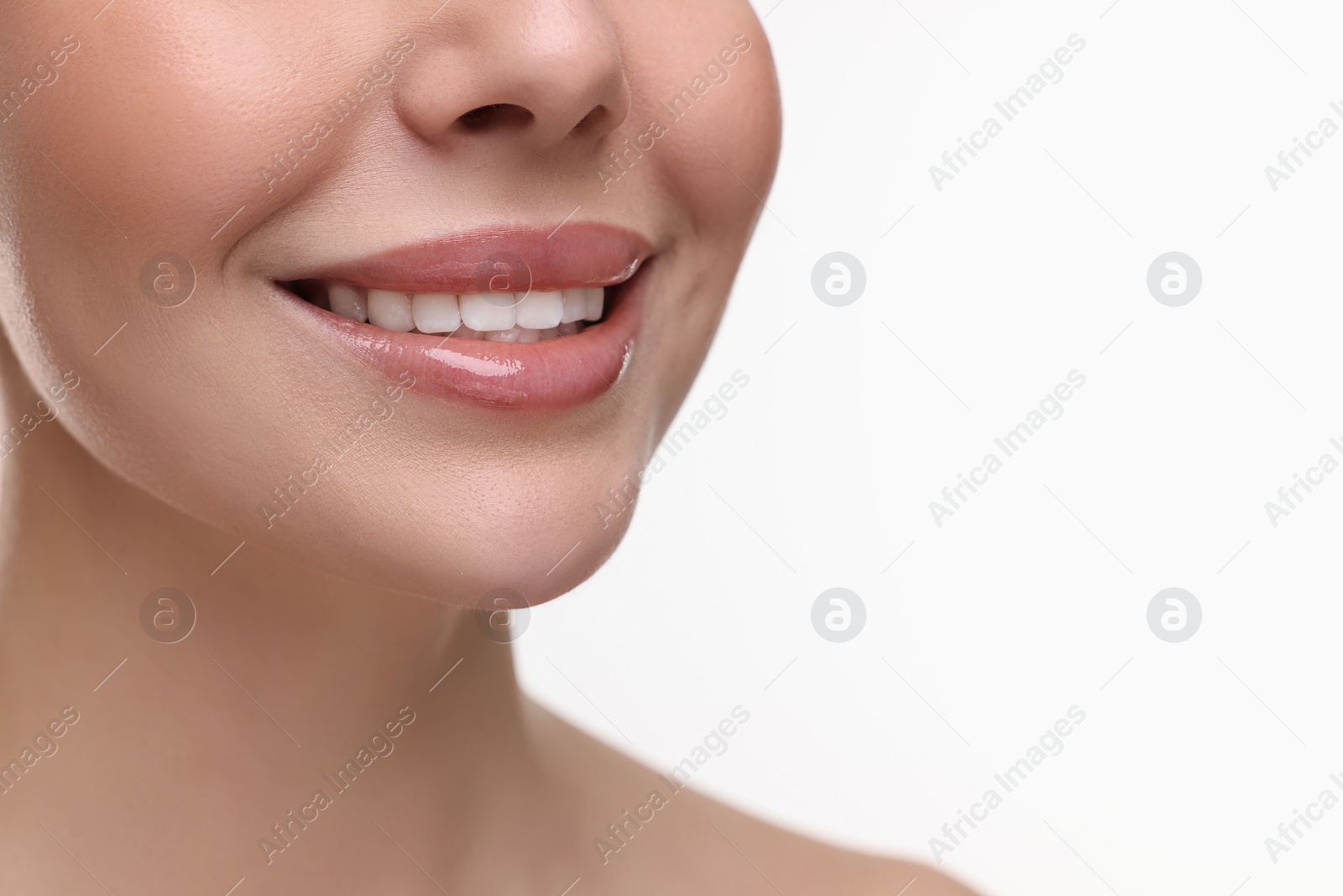 Photo of Woman with beautiful lips smiling on white background, closeup. Space for text