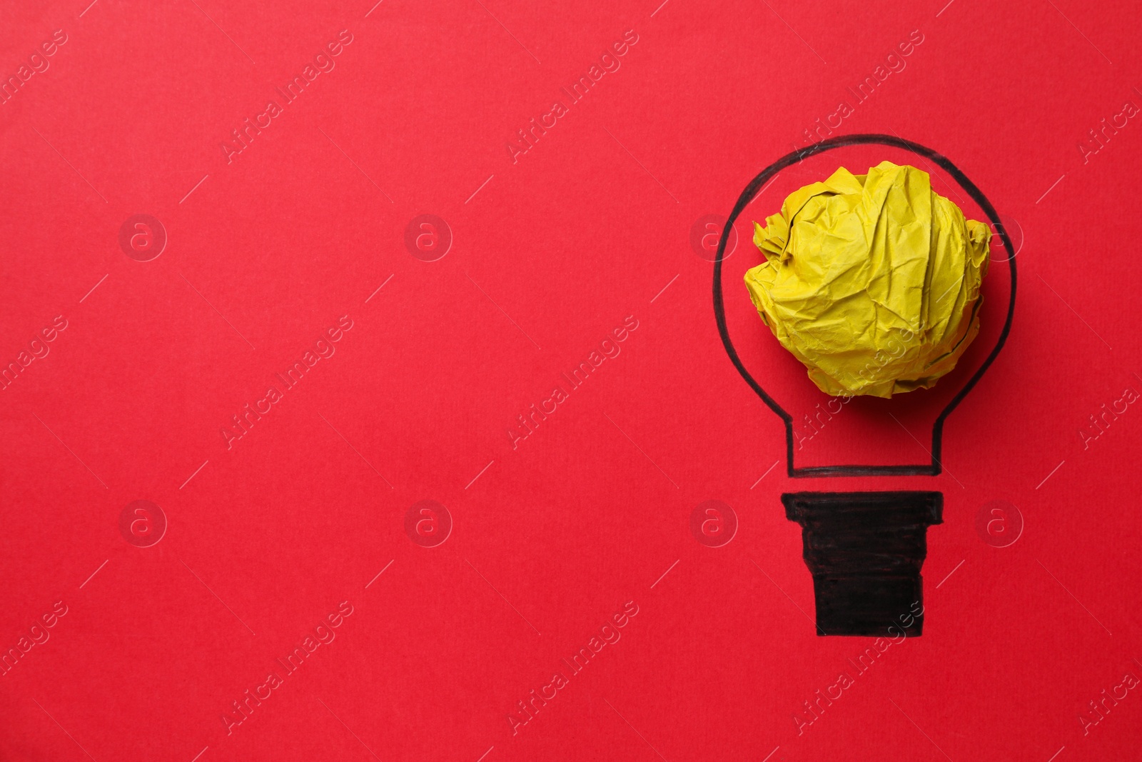 Photo of Idea concept. Light bulb made with crumpled paper and drawing on red background, top view. Space for text