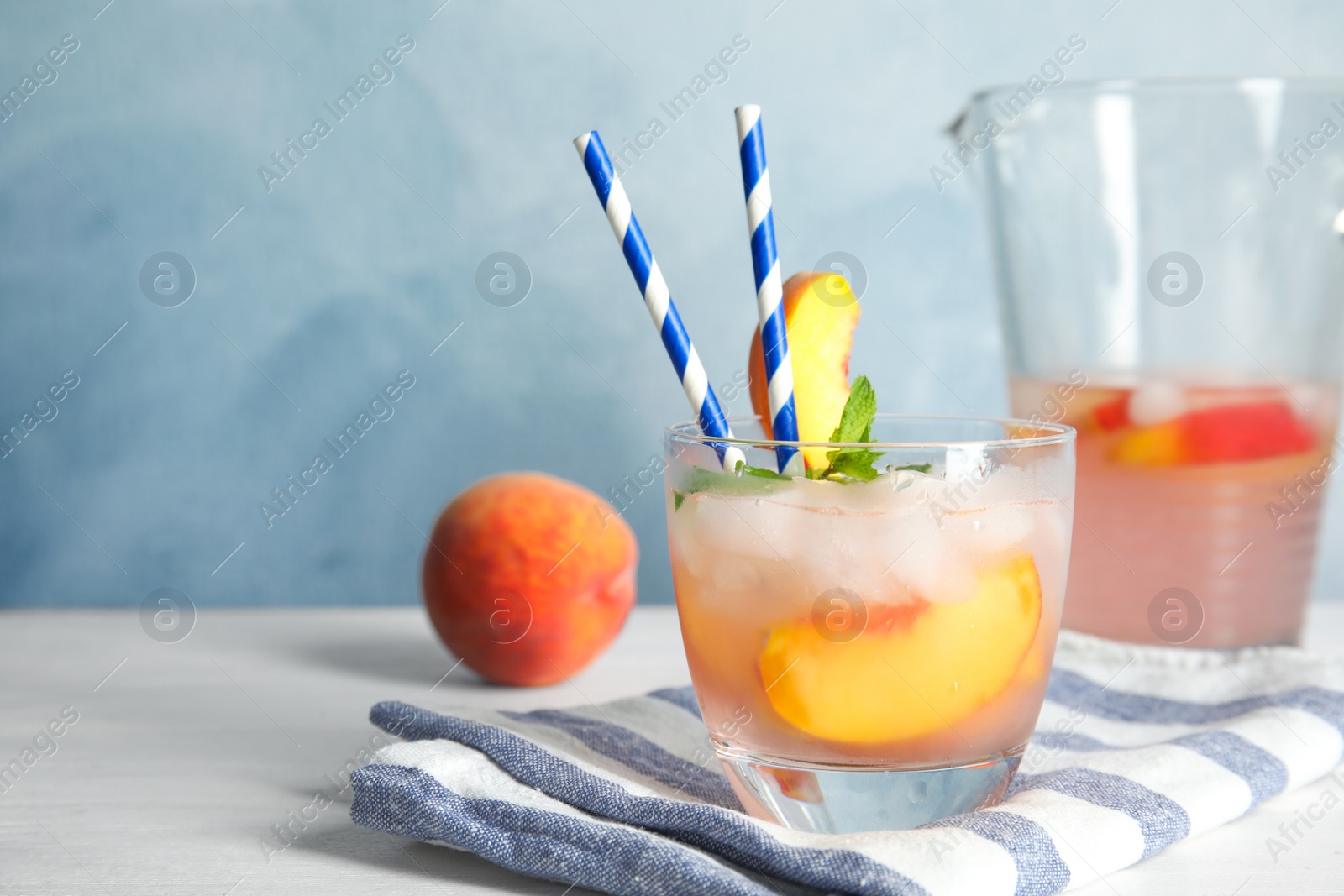 Photo of Tasty peach cocktail on table. Refreshing drink