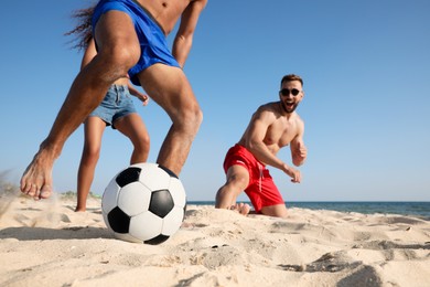 Photo of Group of friends playing football on beach