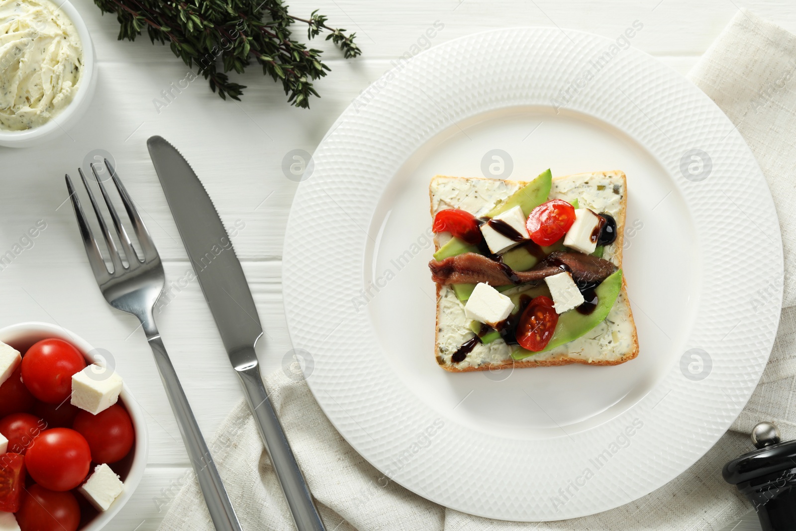 Photo of Flat lay composition with delicious anchovy sandwich on white wooden table