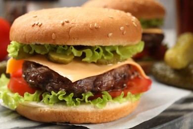 Photo of Tasty hamburger with patty on board, closeup