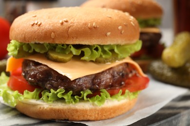 Tasty hamburger with patty on board, closeup