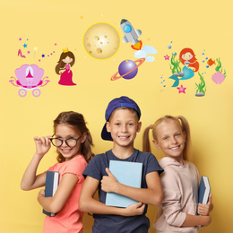 Image of Happy children with books on yellow background. Reading concept