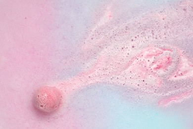 Beautiful pink bath bomb dissolving in water