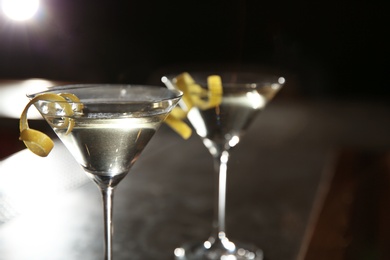 Glasses of lemon drop martini cocktail in bar, closeup. Space for text