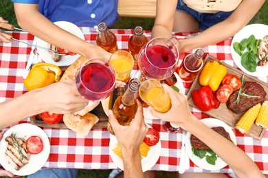 Photo of Friends with drinks at barbecue party outdoors, above view