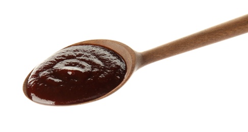 Spoon with hot barbecue sauce on white background