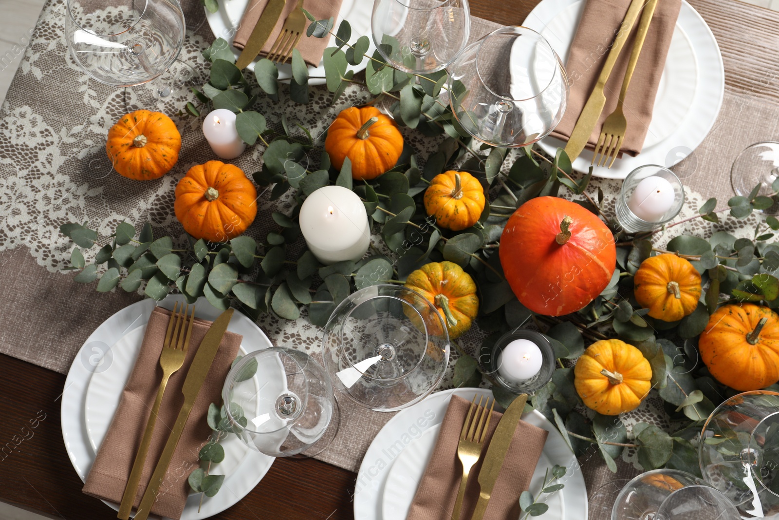 Photo of Beautiful autumn table setting. Plates, cutlery, glasses, pumpkins and floral decor, flat lay