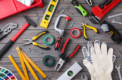 Flat lay composition with different construction tools on wooden background