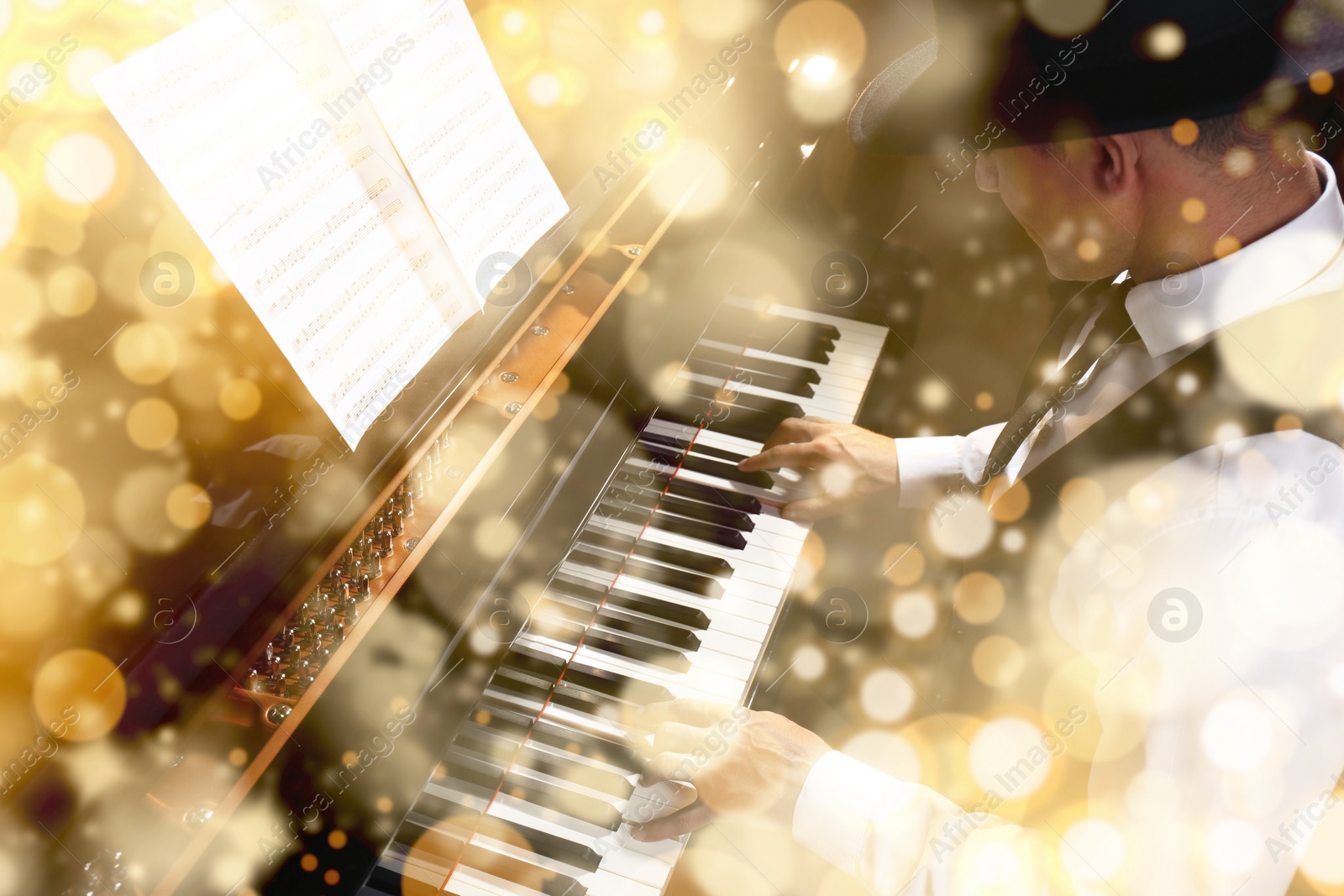 Image of Christmas and New Year music. Man playing piano, bokeh effect