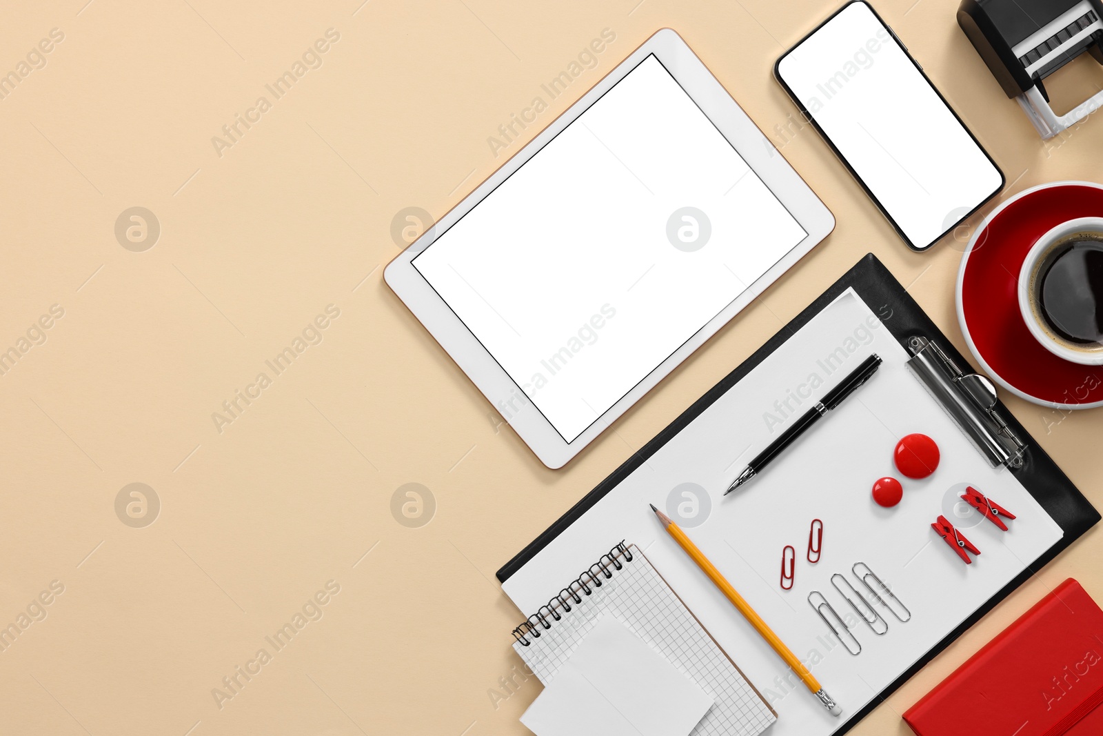 Photo of Modern tablet, smartphone, stationery and coffee on beige background, flat lay. Space for text