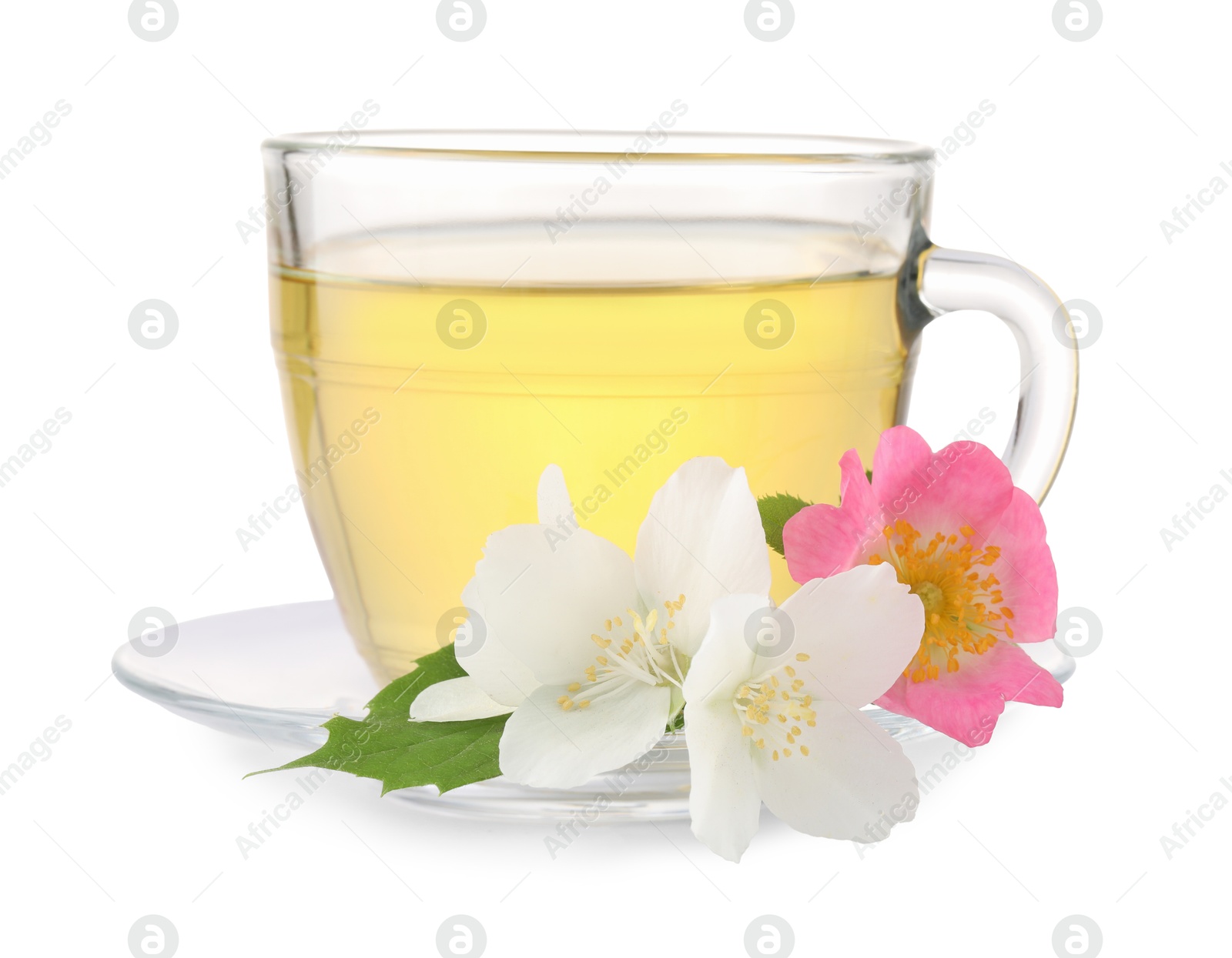 Photo of Aromatic herbal tea in glass cup and flowers isolated on white