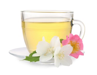 Aromatic herbal tea in glass cup and flowers isolated on white