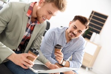 Photo of Business people working on laptop in office. Professional communication