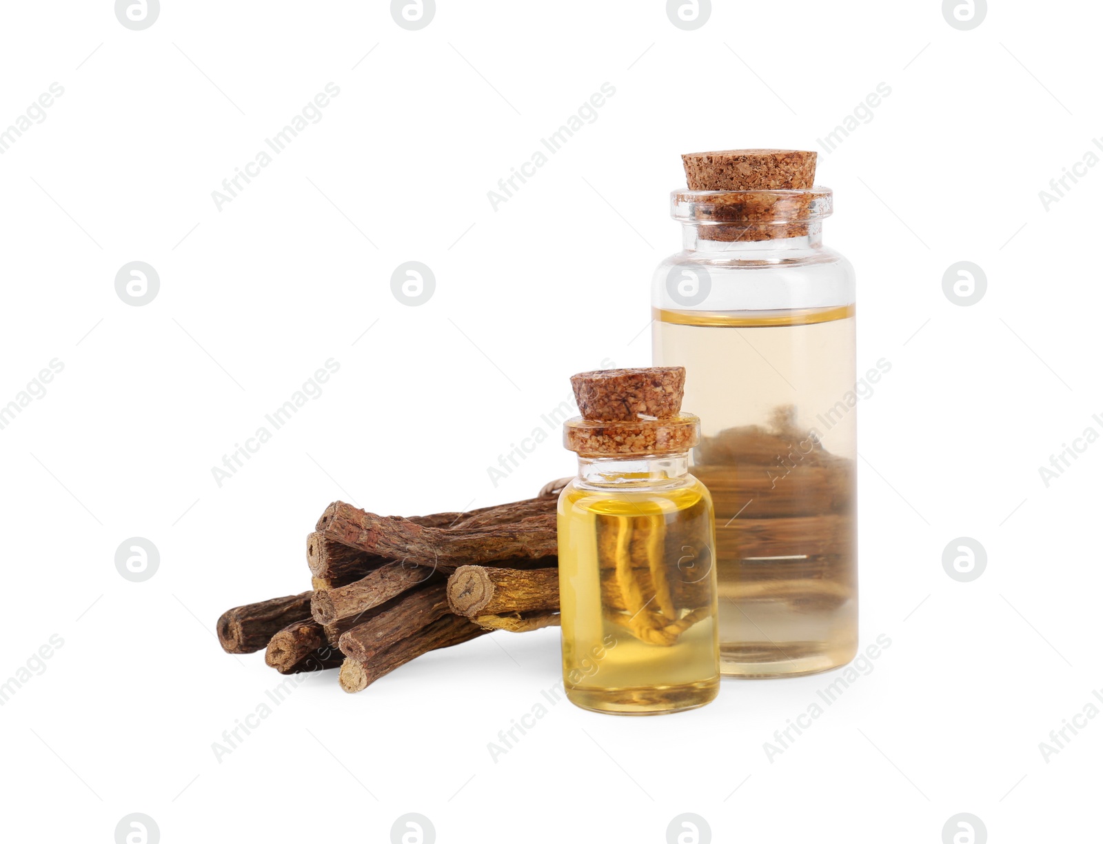 Photo of Dried sticks of licorice root and essential oil isolated on white