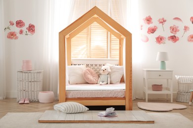 Stylish child room interior with wooden house bed