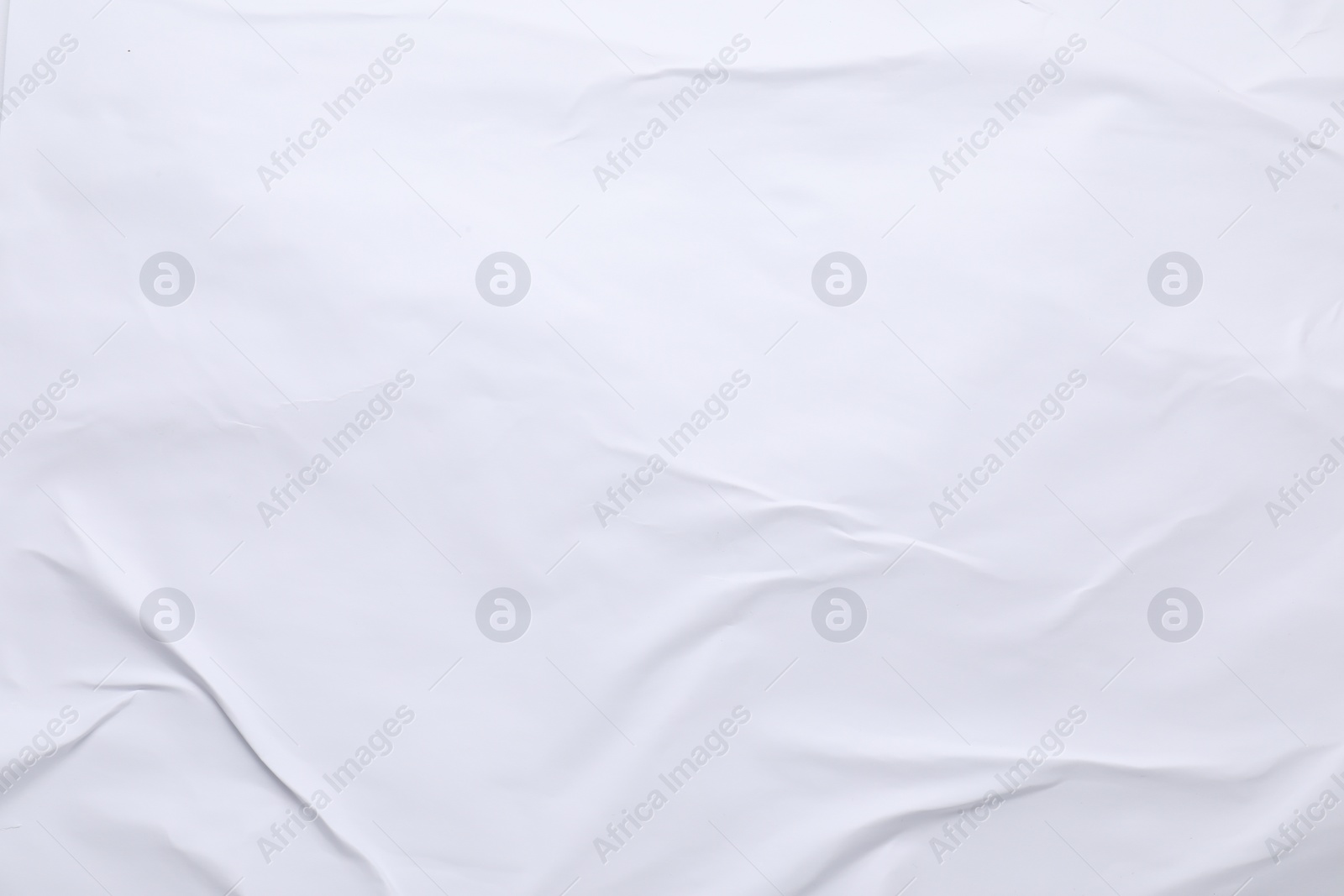 Photo of White crumpled sheet of paper as background, top view. Wall poster