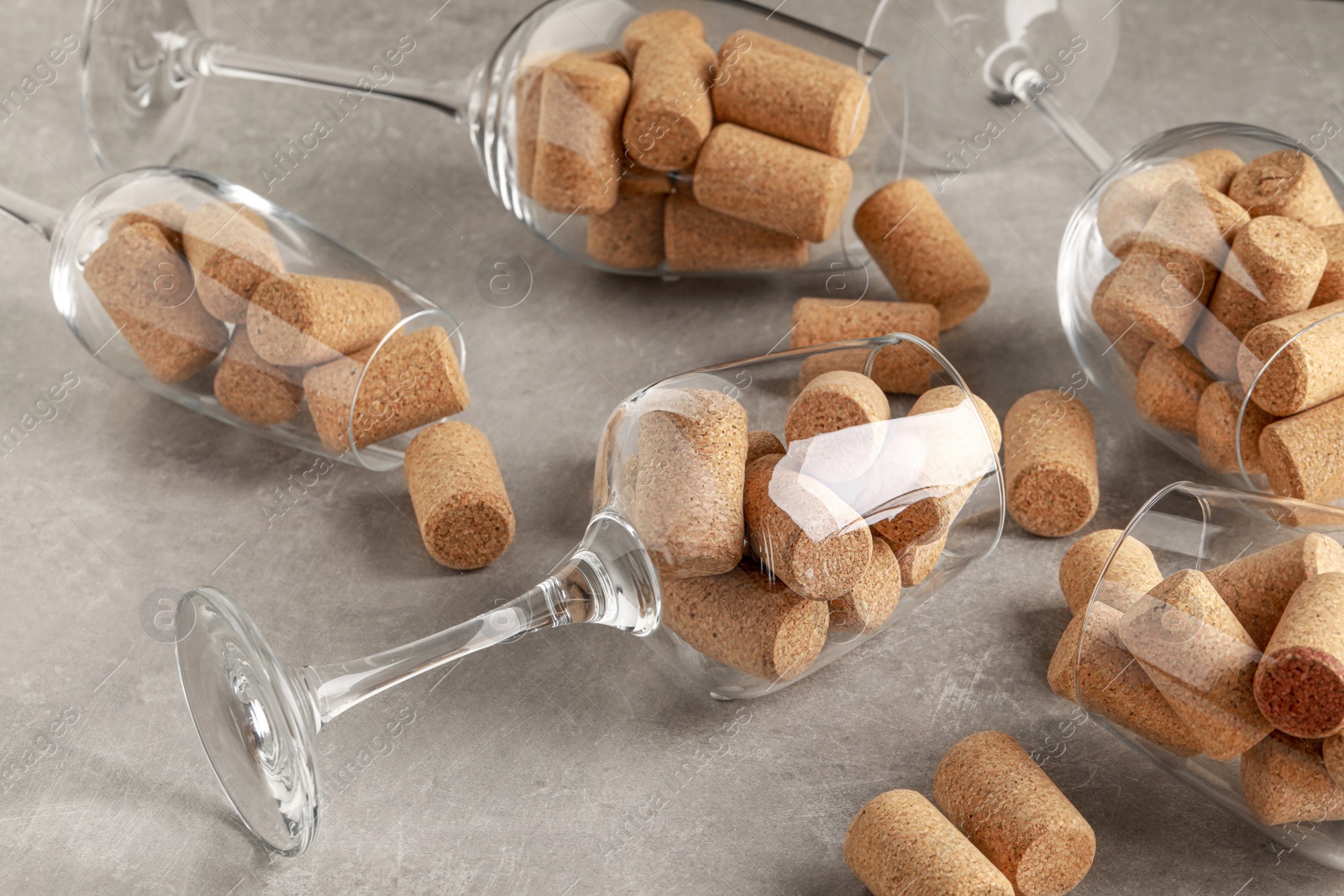 Photo of Glasses with wine corks on light table