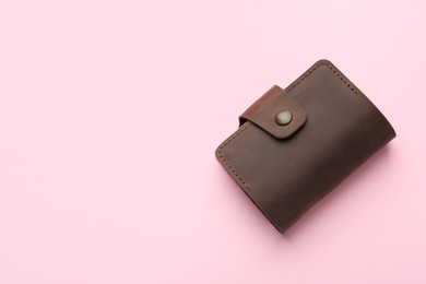 Photo of Stylish leather card holder on pink background, top view. Space for text