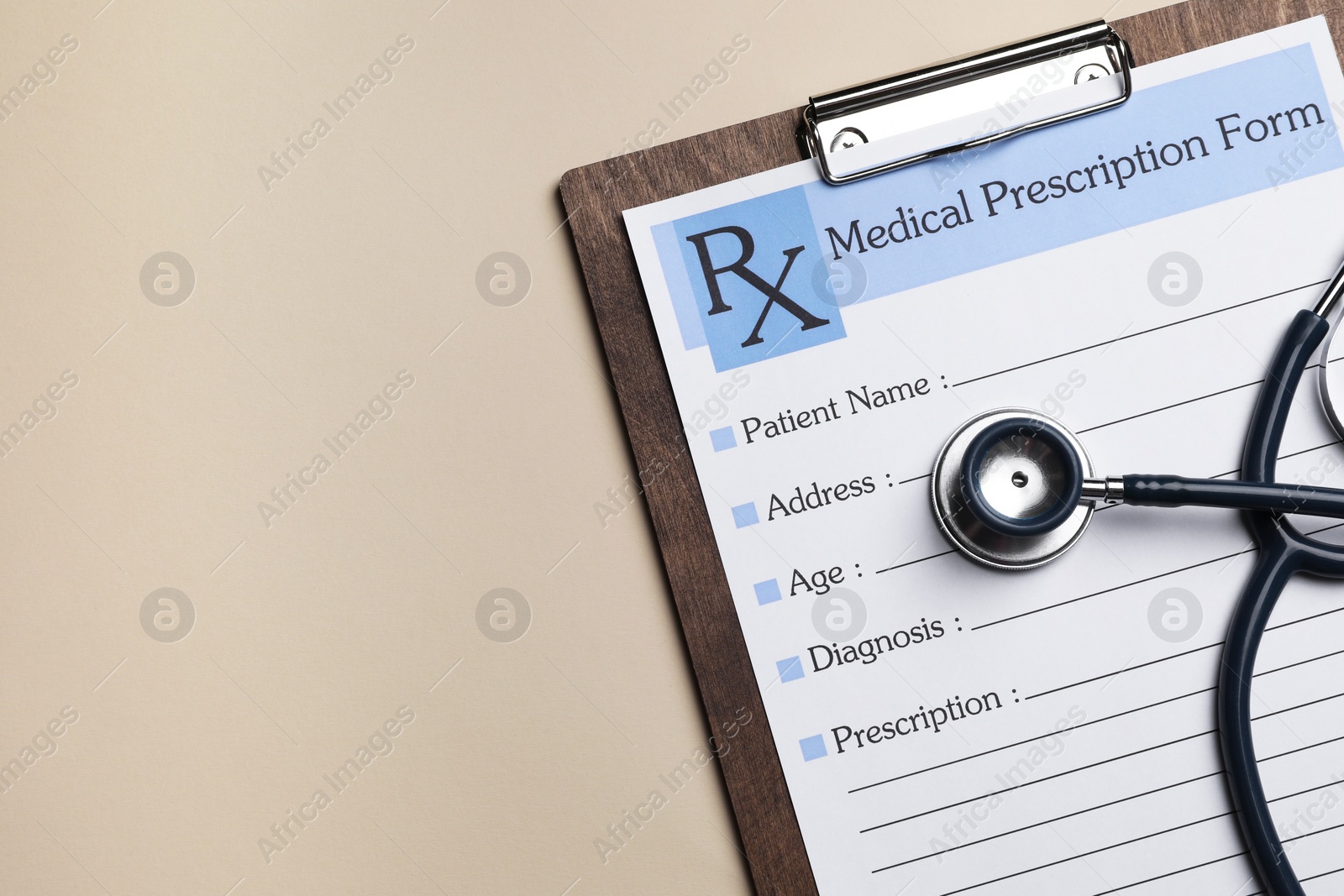 Photo of Clipboard with medical prescription form and stethoscope on beige background, flat lay. Space for text