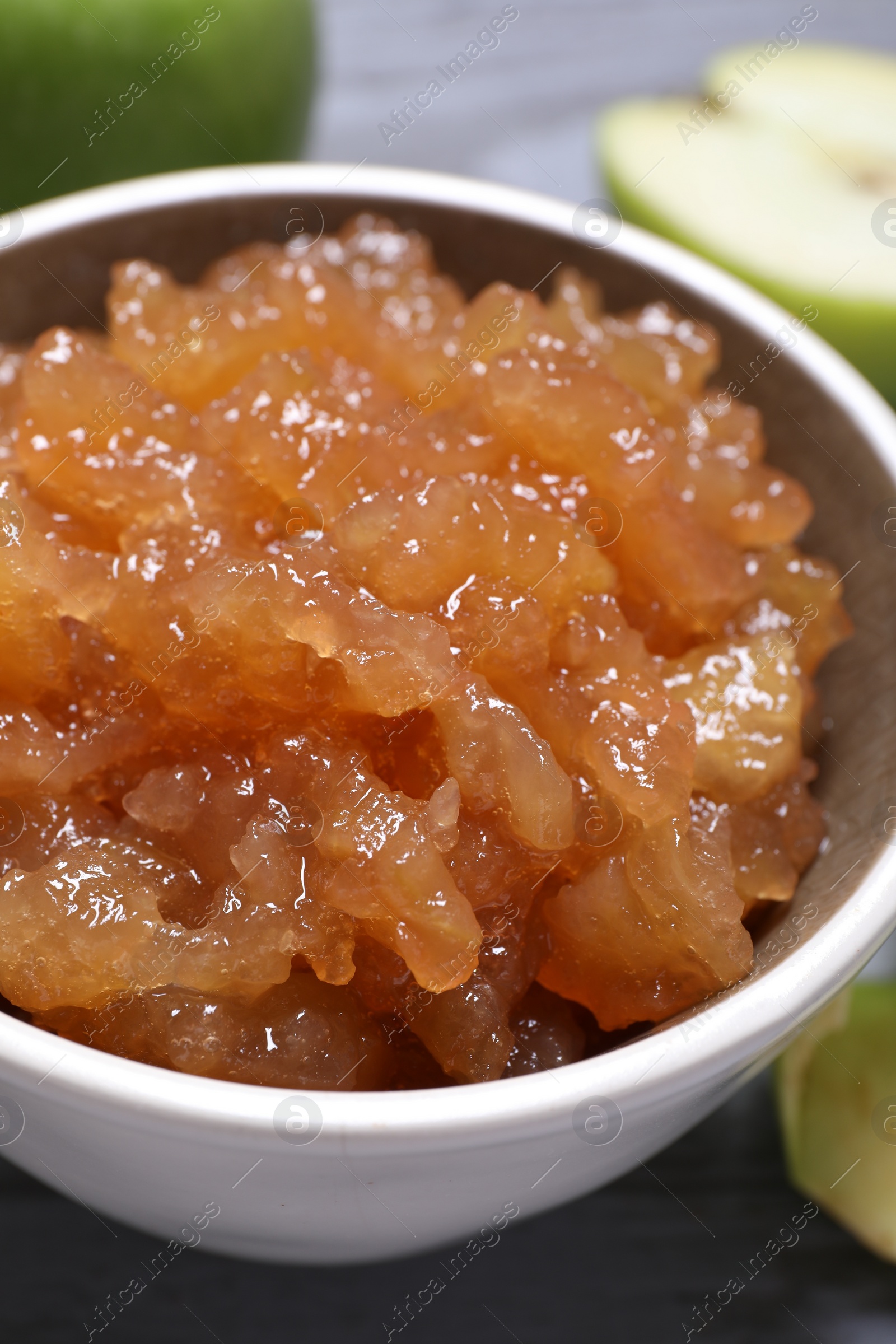 Photo of Delicious apple jam in bowl on table, closeup