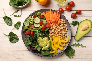 Photo of Balanced diet and vegetarian foods. Plate with different delicious products on wooden table, flat lay