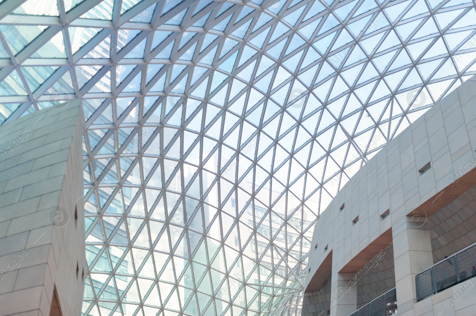 Photo of Modern mall with glass ceiling, low angle view