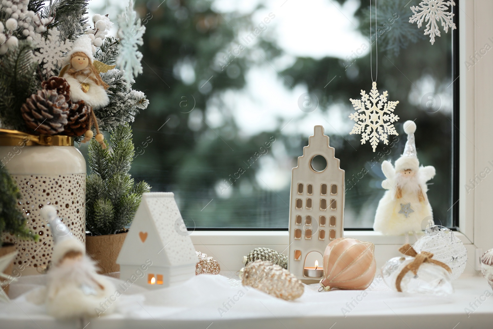 Photo of Many beautiful Christmas decorations and fir branches on window sill indoors