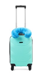 Photo of Soft travel pillow on turquoise suitcase isolated on white