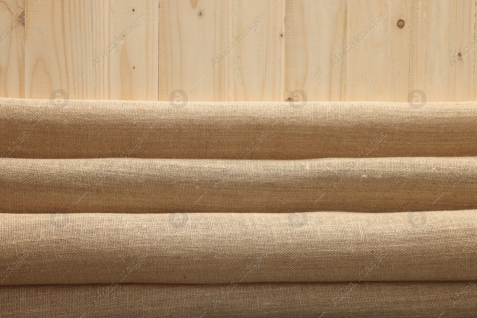 Photo of Burlap fabric on wooden table, top view