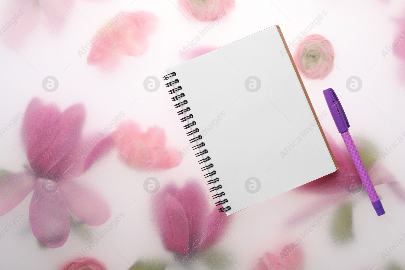 Photo of Guest list. Notebook and pen on spring floral background, flat lay. Space for text