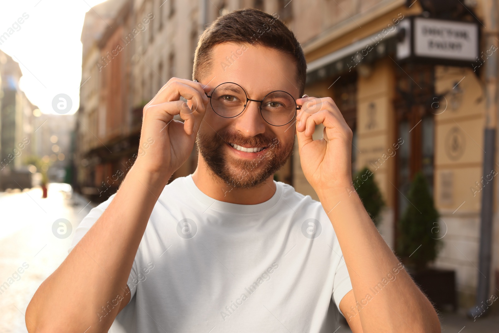 Photo of Portrait of handsome bearded man in glasses outdoors