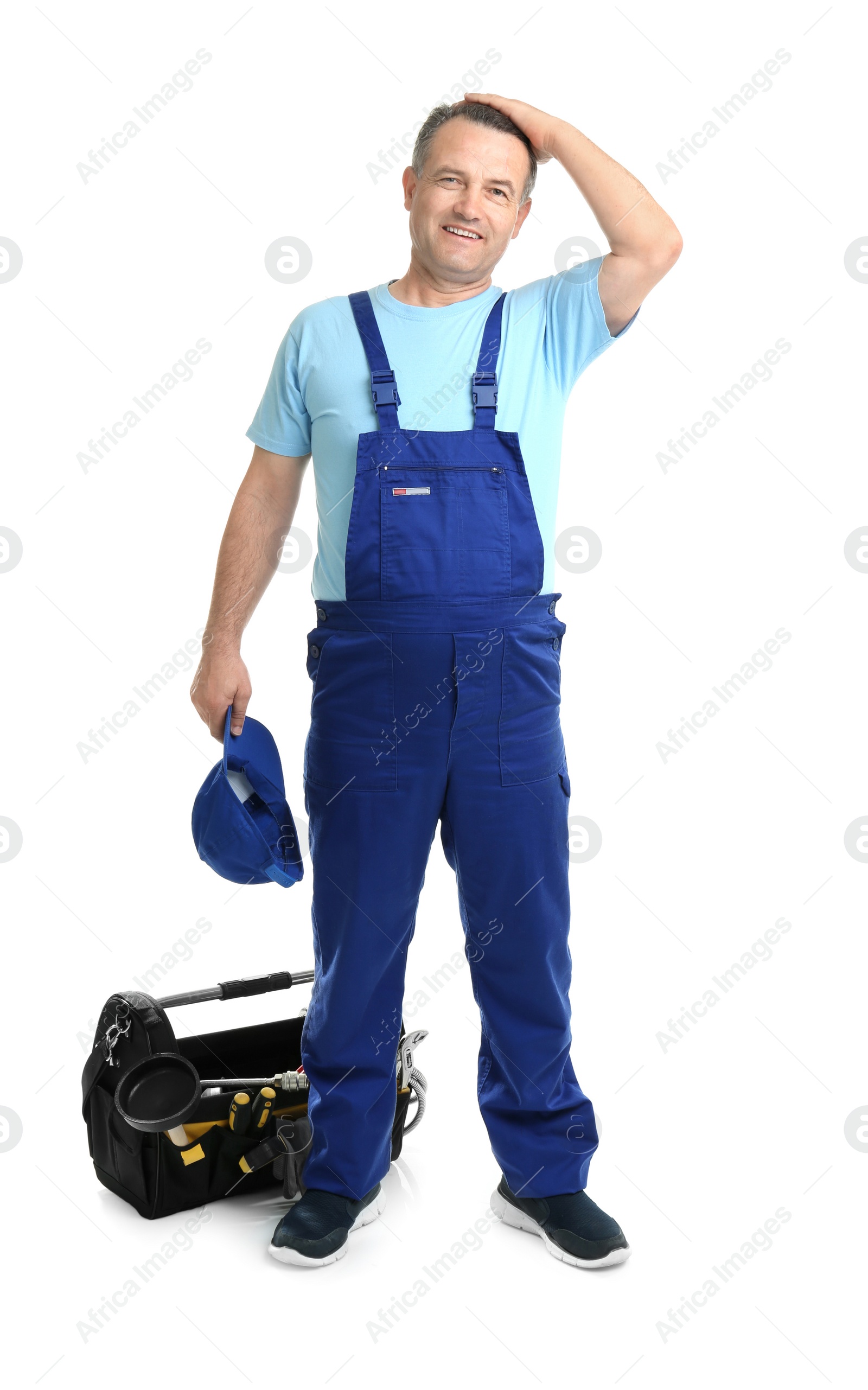 Photo of Mature plumber with tool bag on white background