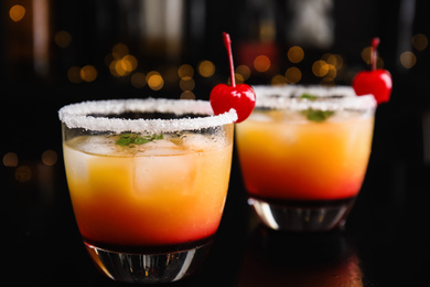 Photo of Fresh alcoholic Tequila Sunrise cocktails on black table